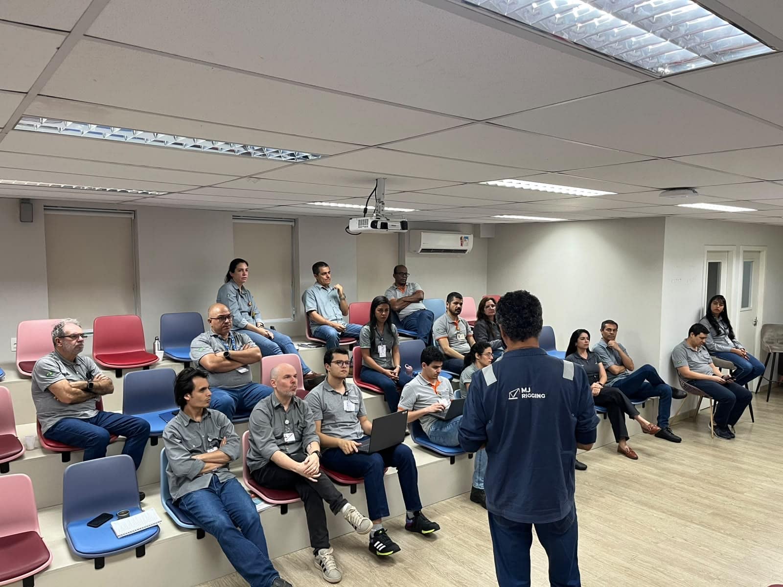 Technical training class gathered in an auditorium, following the instructor’s presentation